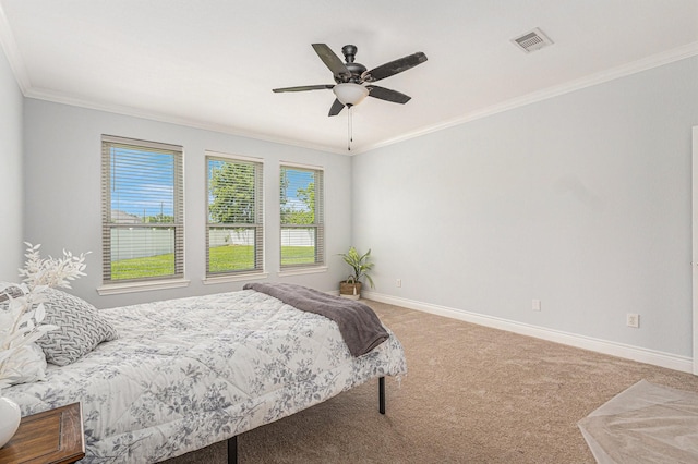 carpeted bedroom featuring visible vents, crown molding, baseboards, and ceiling fan