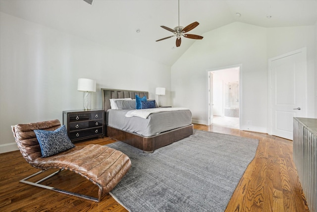 bedroom featuring baseboards, a ceiling fan, wood finished floors, ensuite bath, and high vaulted ceiling