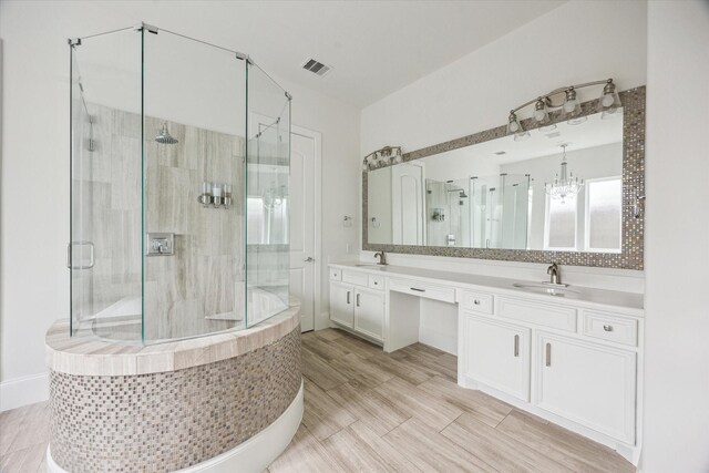 bathroom with a sink and a stall shower