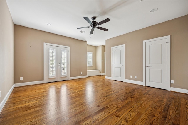 unfurnished bedroom with baseboards, visible vents, a ceiling fan, wood finished floors, and access to outside
