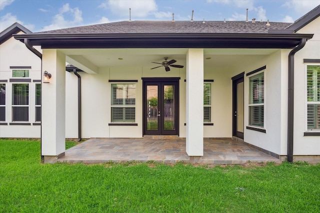 back of property featuring a lawn, french doors, a patio area, and stucco siding