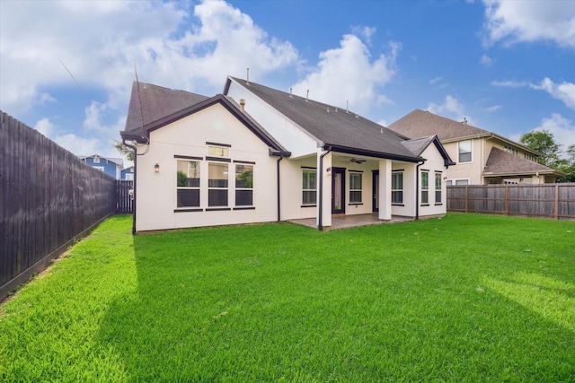 rear view of property with a lawn, a fenced backyard, a ceiling fan, and a patio