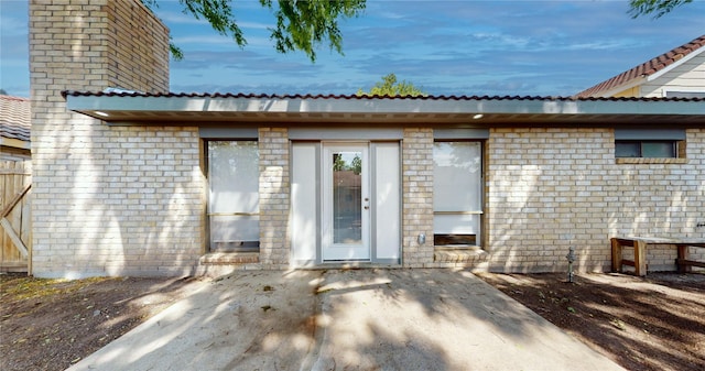 7126 Rio Blanco Dr, Houston, TX 77083 - rear view of house with a chimney, brick siding, and a patio