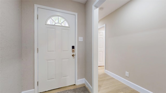 7126 Rio Blanco Dr, Houston, TX 77083 - foyer entrance featuring light wood-type flooring and baseboards