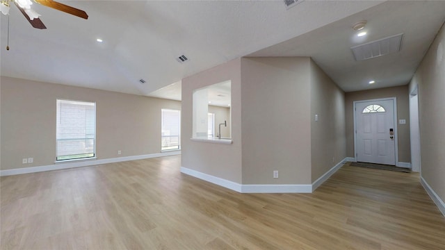 7126 Rio Blanco Dr, Houston, TX 77083 - entryway with lofted ceiling, visible vents, a ceiling fan, light wood-type flooring, and baseboards