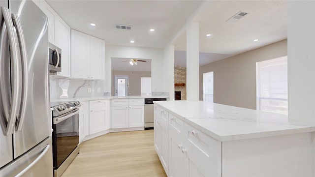 7126 Rio Blanco Dr, Houston, TX 77083 - kitchen with ceiling fan, visible vents, light wood-style floors, and appliances with stainless steel finishes