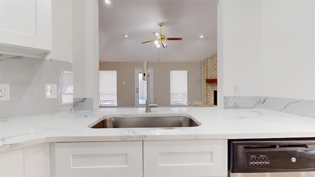 7126 Rio Blanco Dr, Houston, TX 77083 - kitchen featuring light stone counters, a ceiling fan, a sink, dishwasher, and white cabinets