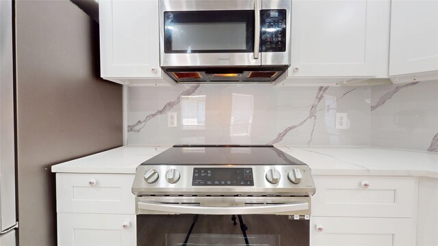7126 Rio Blanco Dr, Houston, TX 77083 - kitchen featuring white cabinets, backsplash, light stone counters, and stainless steel appliances