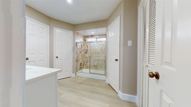 7126 Rio Blanco Dr, Houston, TX 77083 - full bathroom with a shower stall, wood finished floors, vanity, a closet, and baseboards