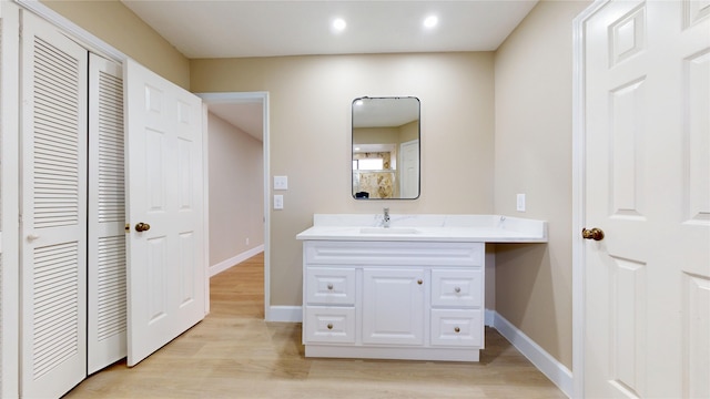 7126 Rio Blanco Dr, Houston, TX 77083 - bathroom with recessed lighting, wood finished floors, vanity, and baseboards