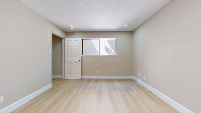 7126 Rio Blanco Dr, Houston, TX 77083 - spare room featuring light wood finished floors, baseboards, a textured ceiling, and recessed lighting