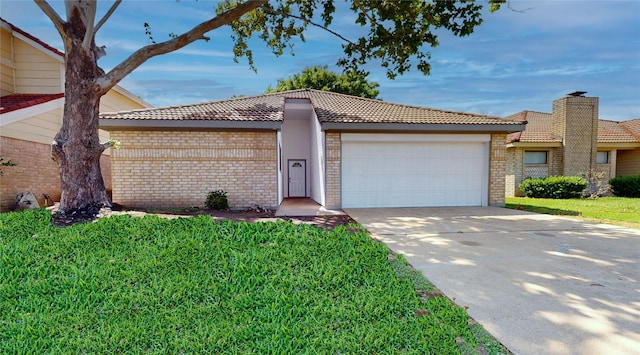 7126 Rio Blanco Dr, Houston, TX 77083 - view of front of property featuring a garage, brick siding, a tile roof, and driveway