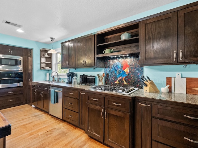 kitchen with visible vents, dark brown cabinets, open shelves, and appliances with stainless steel finishes