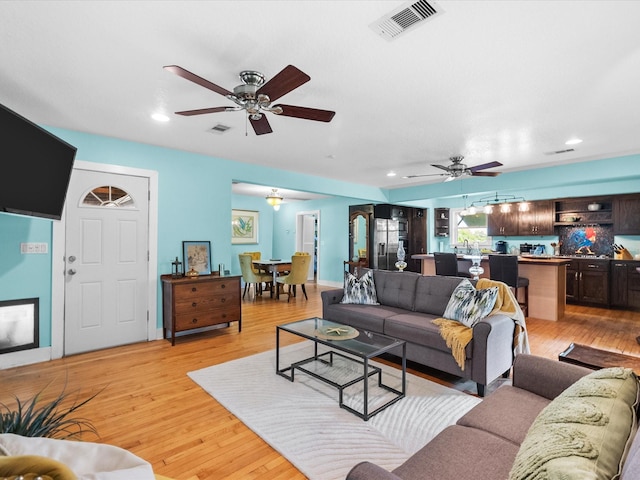 939 17th St, San Leon, TX 77539 - living room featuring ceiling fan, light wood-style floors, and recessed lighting
