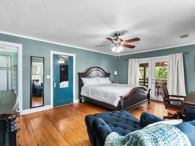 bedroom featuring access to outside, wood-type flooring, visible vents, french doors, and crown molding