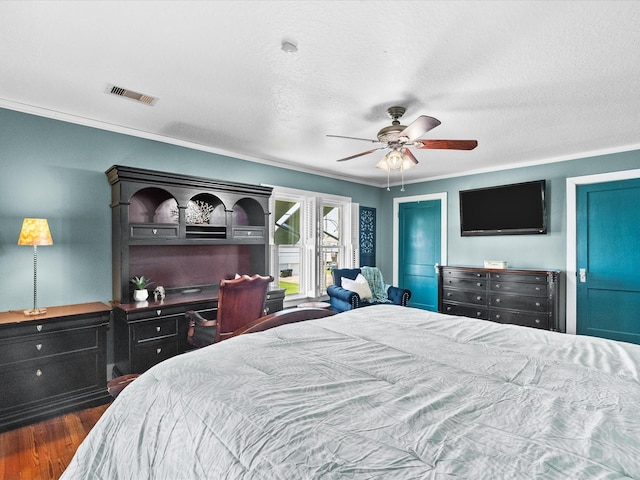 939 17th St, San Leon, TX 77539 - bedroom with dark wood-style floors, ornamental molding, and a ceiling fan