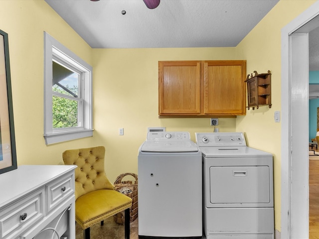 laundry room with wood finished floors, ceiling fan, separate washer and dryer, and cabinet space