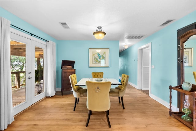939 17th St, San Leon, TX 77539 - dining space with french doors, light wood finished floors, and baseboards