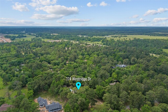 birds eye view of property with a wooded view