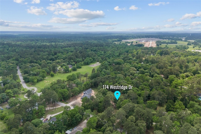 drone / aerial view featuring a view of trees