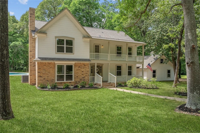 view of front of home with covered porch, a chimney, a balcony, and roof with shingles