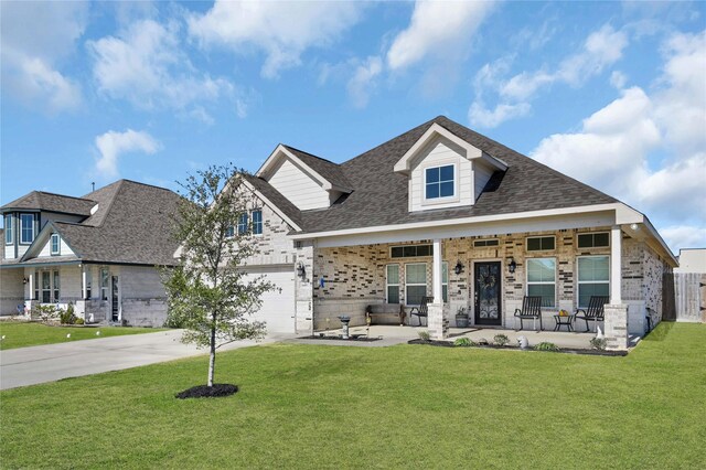 14315 Pecos Ln, Baytown, TX 77523 - view of front facade featuring brick siding, concrete driveway, a front lawn, and a porch