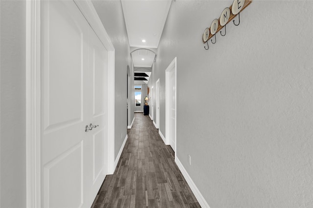 14315 Pecos Ln, Baytown, TX 77523 - hallway featuring dark wood-style floors, baseboards, recessed lighting, and arched walkways