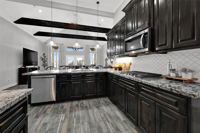 14315 Pecos Ln, Baytown, TX 77523 - kitchen with stainless steel appliances, a sink, decorative backsplash, wood finished floors, and ornamental molding