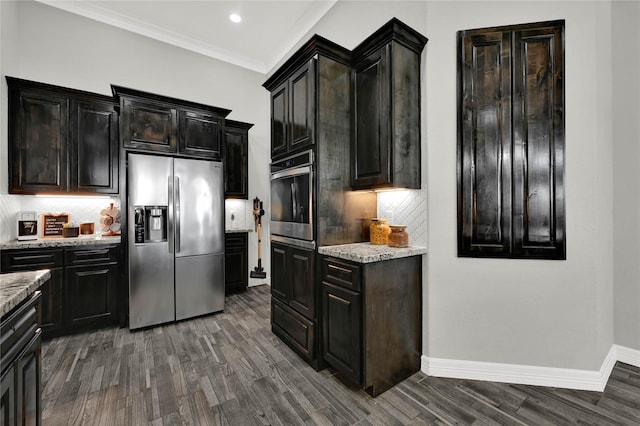 14315 Pecos Ln, Baytown, TX 77523 - kitchen with appliances with stainless steel finishes, dark wood-style flooring, light stone counters, decorative backsplash, and recessed lighting