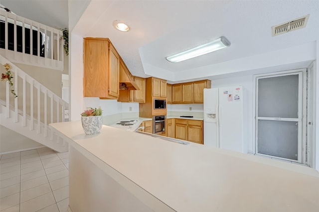 kitchen featuring built in microwave, visible vents, white refrigerator with ice dispenser, light countertops, and light tile patterned floors