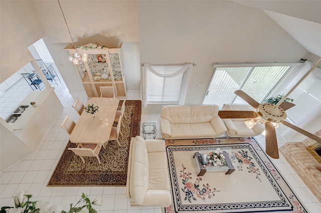 tiled living room with a chandelier and vaulted ceiling