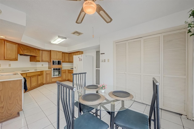 dining space featuring a ceiling fan, visible vents, and light tile patterned floors