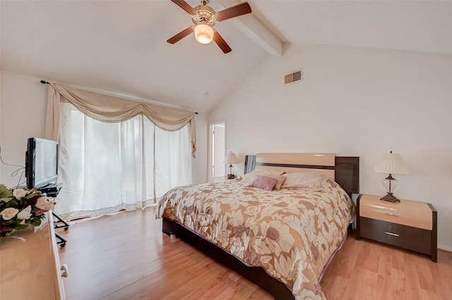 bedroom with light wood finished floors, lofted ceiling with beams, visible vents, and ceiling fan