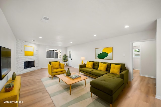 4207 Marlborough Dr, Houston, TX 77092 - living area with light wood finished floors, recessed lighting, a fireplace, and baseboards