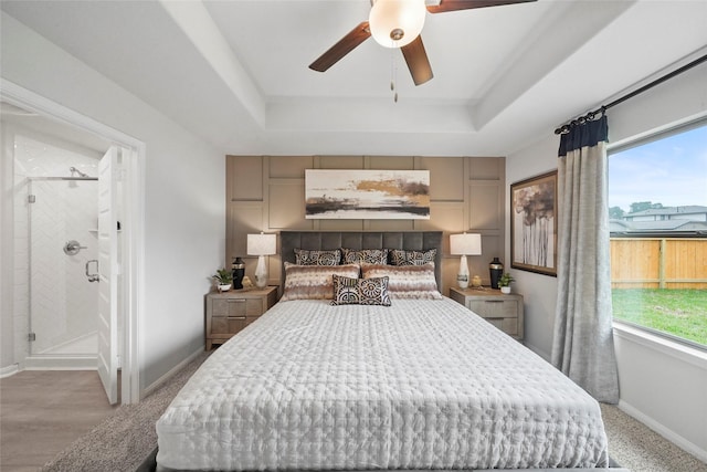 810 Clear Valley Ln, Dayton, TX 77535 - bedroom with baseboards, a ceiling fan, a tray ceiling, and connected bathroom