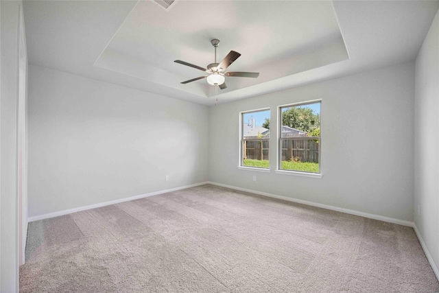 810 Clear Valley Ln, Dayton, TX 77535 - spare room featuring a tray ceiling, carpet, and ceiling fan
