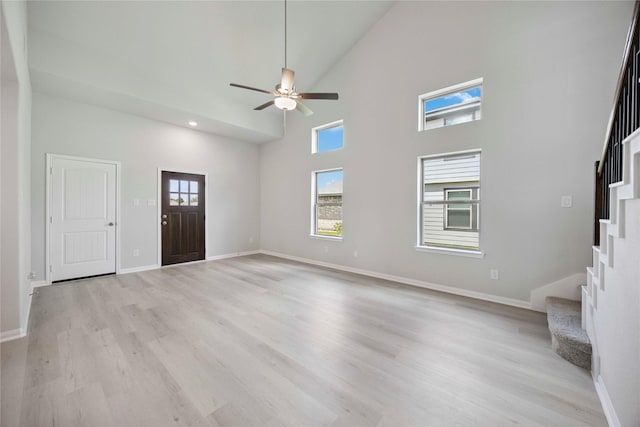 810 Clear Valley Ln, Dayton, TX 77535 - unfurnished living room featuring stairs, high vaulted ceiling, light wood-style flooring, ceiling fan, and recessed lighting