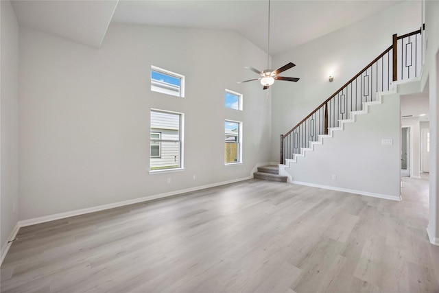 810 Clear Valley Ln, Dayton, TX 77535 - unfurnished living room with stairway, high vaulted ceiling, light wood-style flooring, and a ceiling fan
