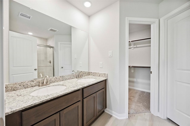 810 Clear Valley Ln, Dayton, TX 77535 - bathroom with a stall shower, a walk in closet, and double vanity