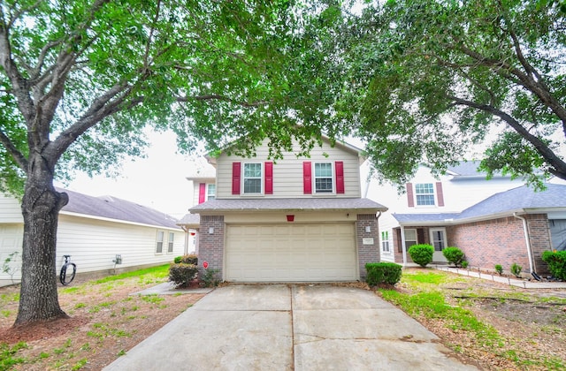 traditional-style house featuring an attached garage, brick siding, and concrete driveway