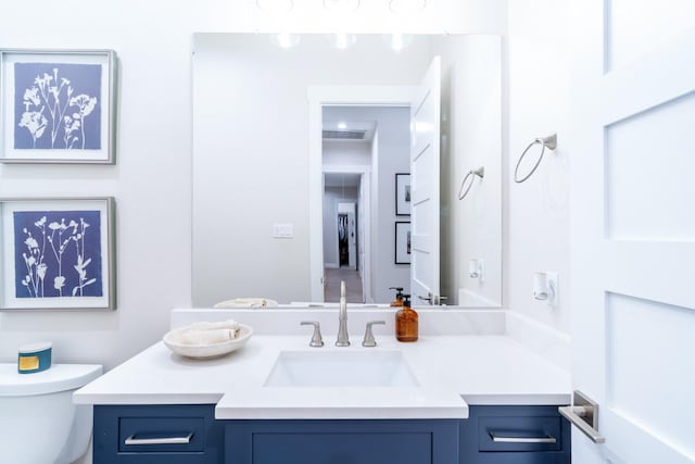 bathroom with toilet and vanity