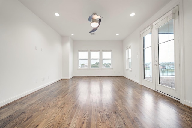 interior space featuring recessed lighting, baseboards, and wood finished floors