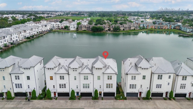 birds eye view of property featuring a water view and a residential view