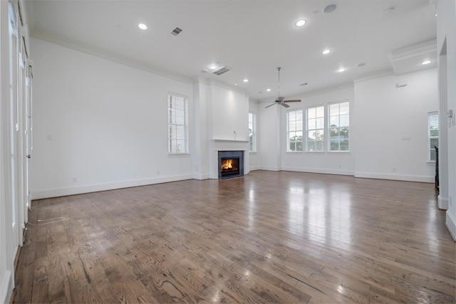 unfurnished living room with crown molding, recessed lighting, and plenty of natural light