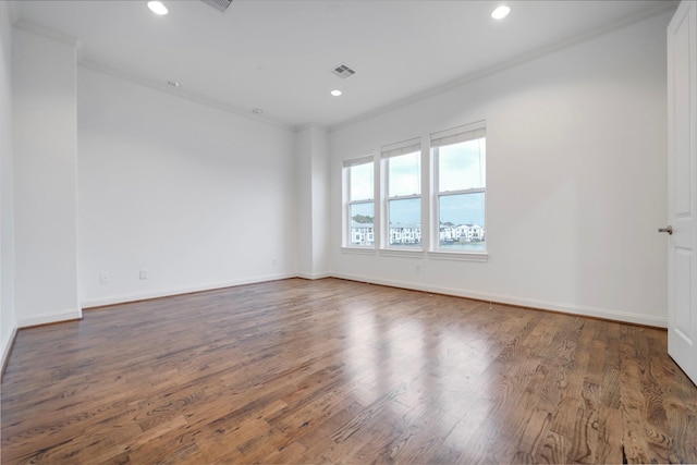 unfurnished room featuring crown molding, recessed lighting, wood finished floors, and visible vents