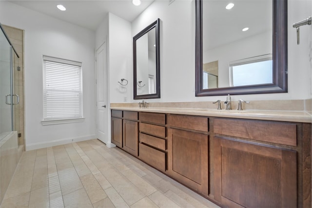 bathroom featuring double vanity, recessed lighting, a shower stall, and a healthy amount of sunlight