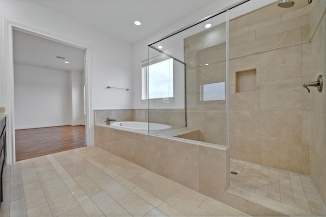 bathroom with a garden tub, vanity, tiled shower, recessed lighting, and tile patterned floors