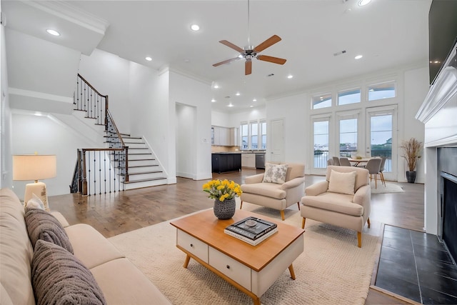 living room featuring recessed lighting, ceiling fan, wood finished floors, and stairway