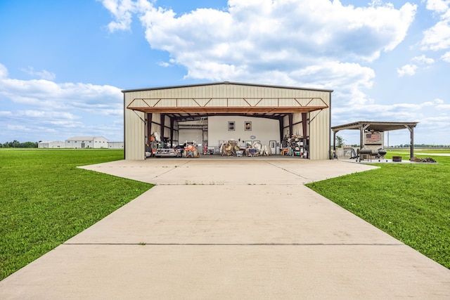 view of pole building with a lawn, a carport, and driveway