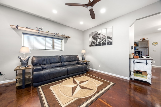 living room with a ceiling fan, baseboards, finished concrete floors, and recessed lighting